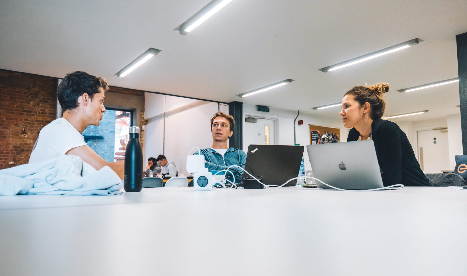 Nina and Max discussing financial modelling with Sylvan from the EF team