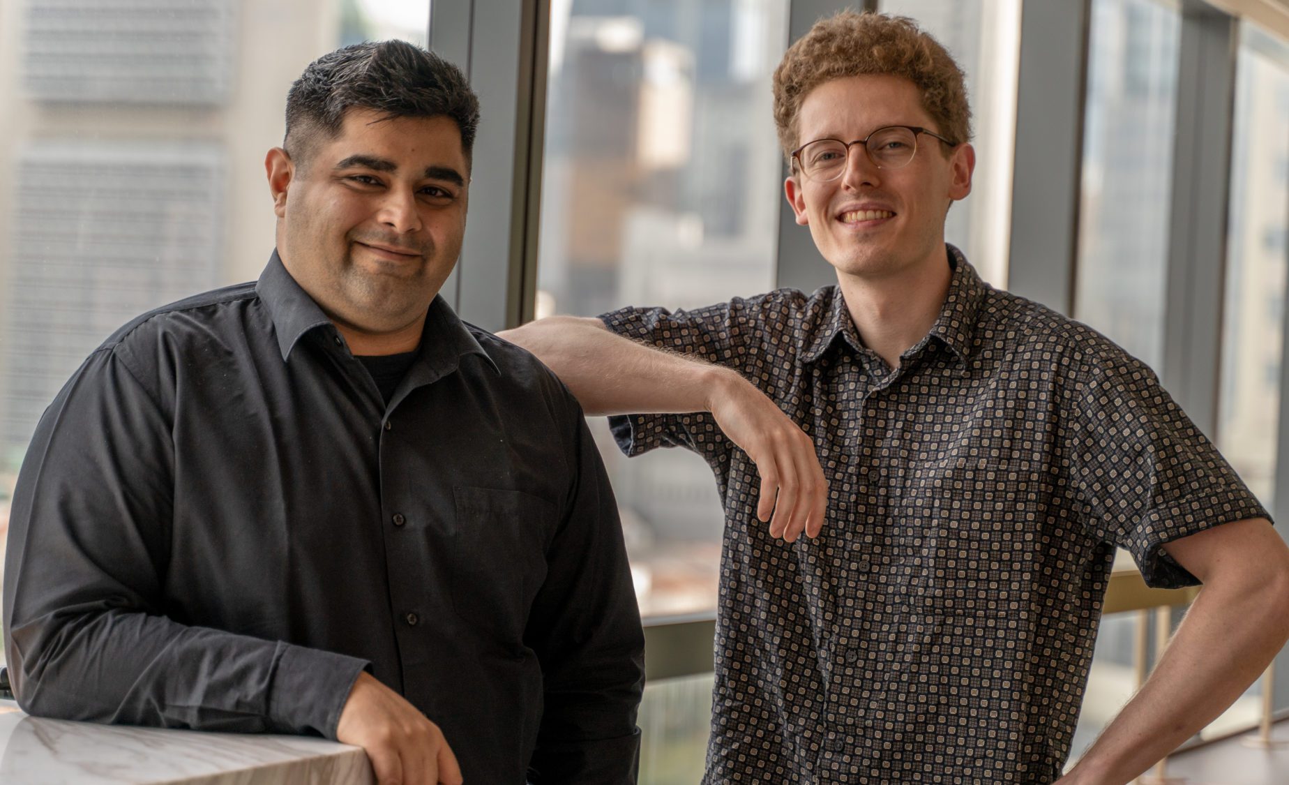 Two men smiling