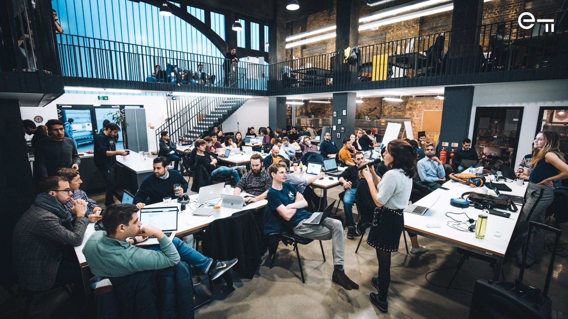 Woman in an office speaking to a group of people 
