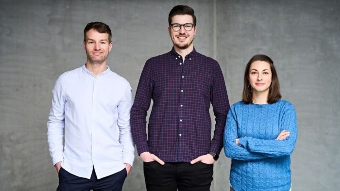 Two men and one woman smiling